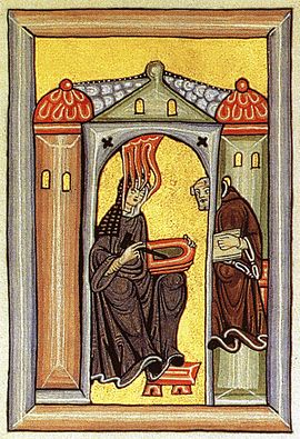 Hildegard von Bingen receives a divine inspiration and passes it on to her scribe. From the Rupertsberg Codex of Liber Scivias.