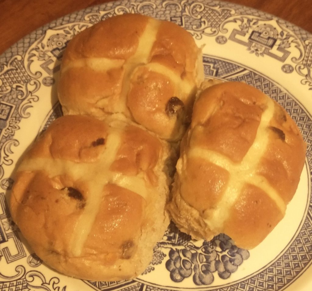 photo of three hot cross buns on a blue transfer ware plate
