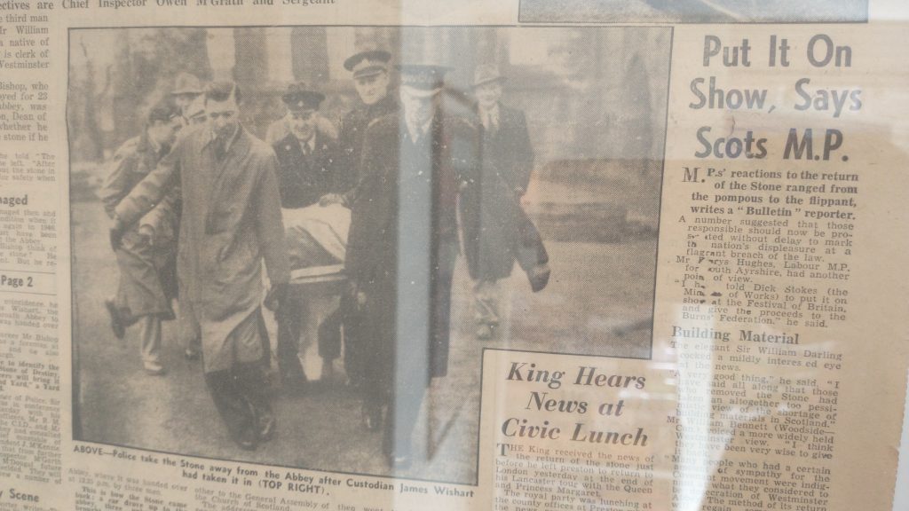 Newspaper cutting showing the Stone being taken from Arbroath Abbey
Photo of six people, including policemen carrying away the Stone of Scone from Arbroath Abbey