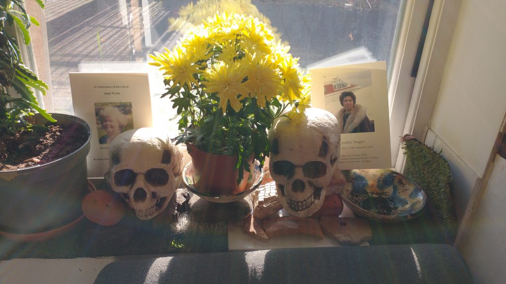 Picture of window sill with skulls, Chrysanthemums and pictures of remembrance
