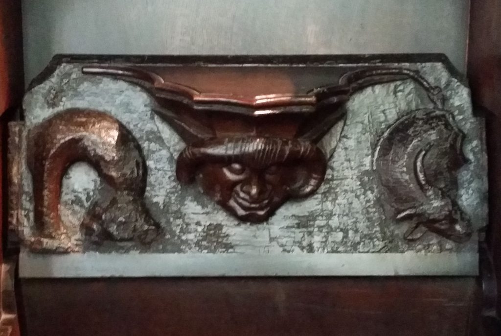 medieval monks seat showing carving of a Horned man (with Ram's Horn) at Stratford on Avon Holy Trinity Church) Photo: K Flude