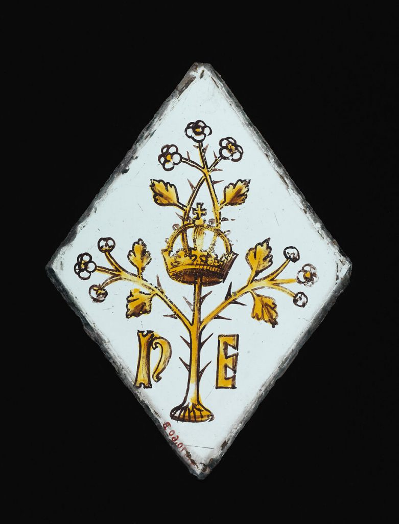 a triangle of stained glass on a black background.
A 'Quarry' of Stained Glass showing the Crown, a hawthorn Bush and initials representing Henry VII and his, Queen, Elizabeth of York.  Possibly from Surrey. Early 16th Century and from the Metropolitan Museum of Art (Public Domain).