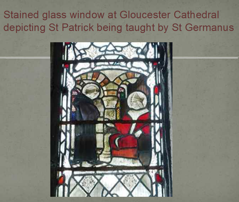 stained glass window from Gloucester Cathedral of St Patrick being taught by St Germanus